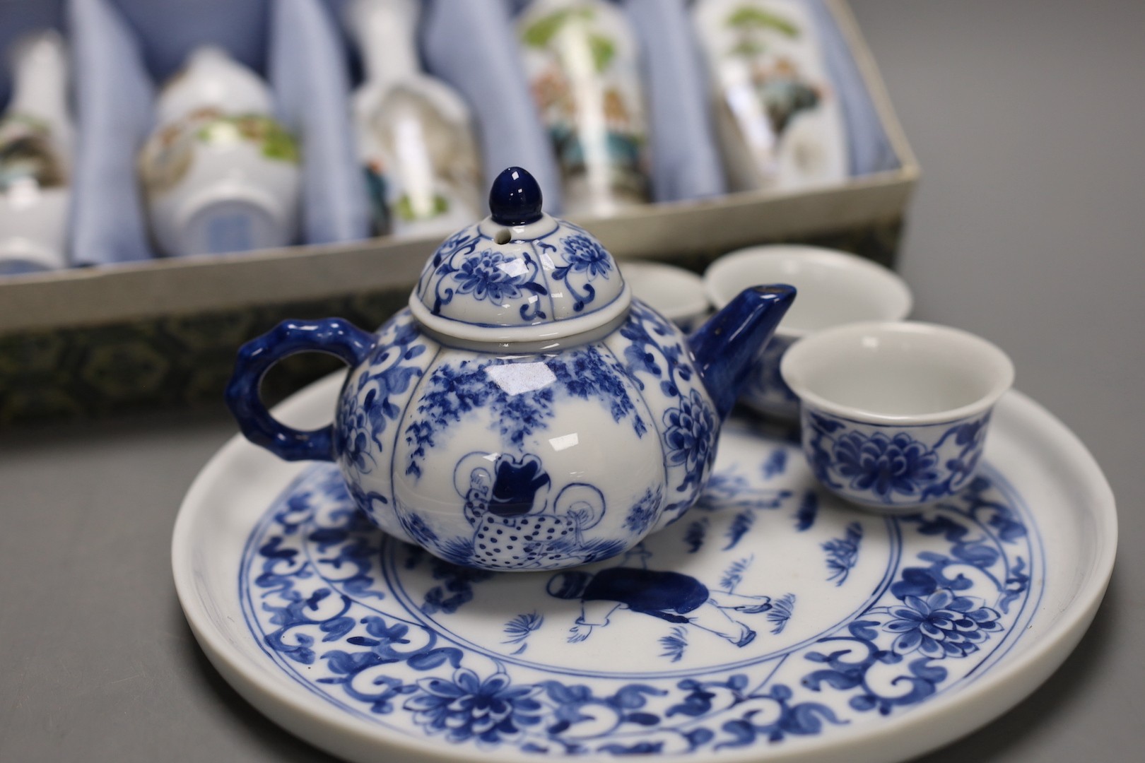 A Chinese blue and white miniature teapot, 6 matching cups and a tray and a box of five vases